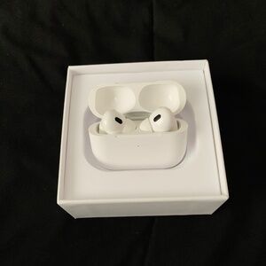 White Apple AirPod Pros still in case